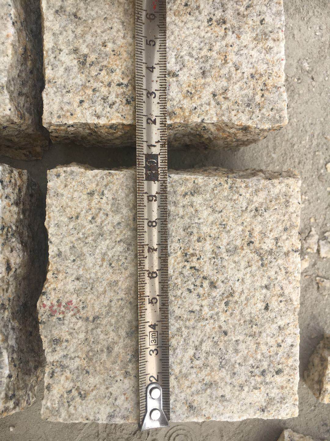 Natural Split Yellow Granite Cobble Stone Granite — Checking cobble length against the agreed size tolerance at Sun Young Stone