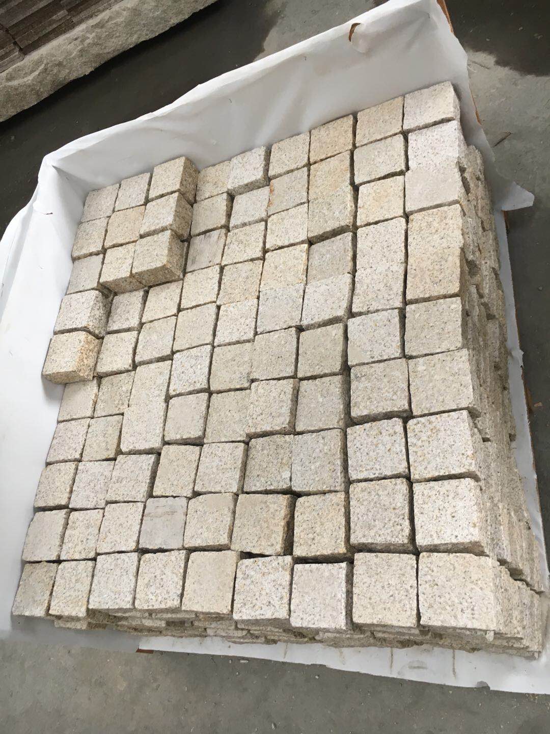 Natural Split Yellow Granite Cobble Stone Granite — Cobbles packed into a lined wooden crate for sea freight at Sun Young Stone