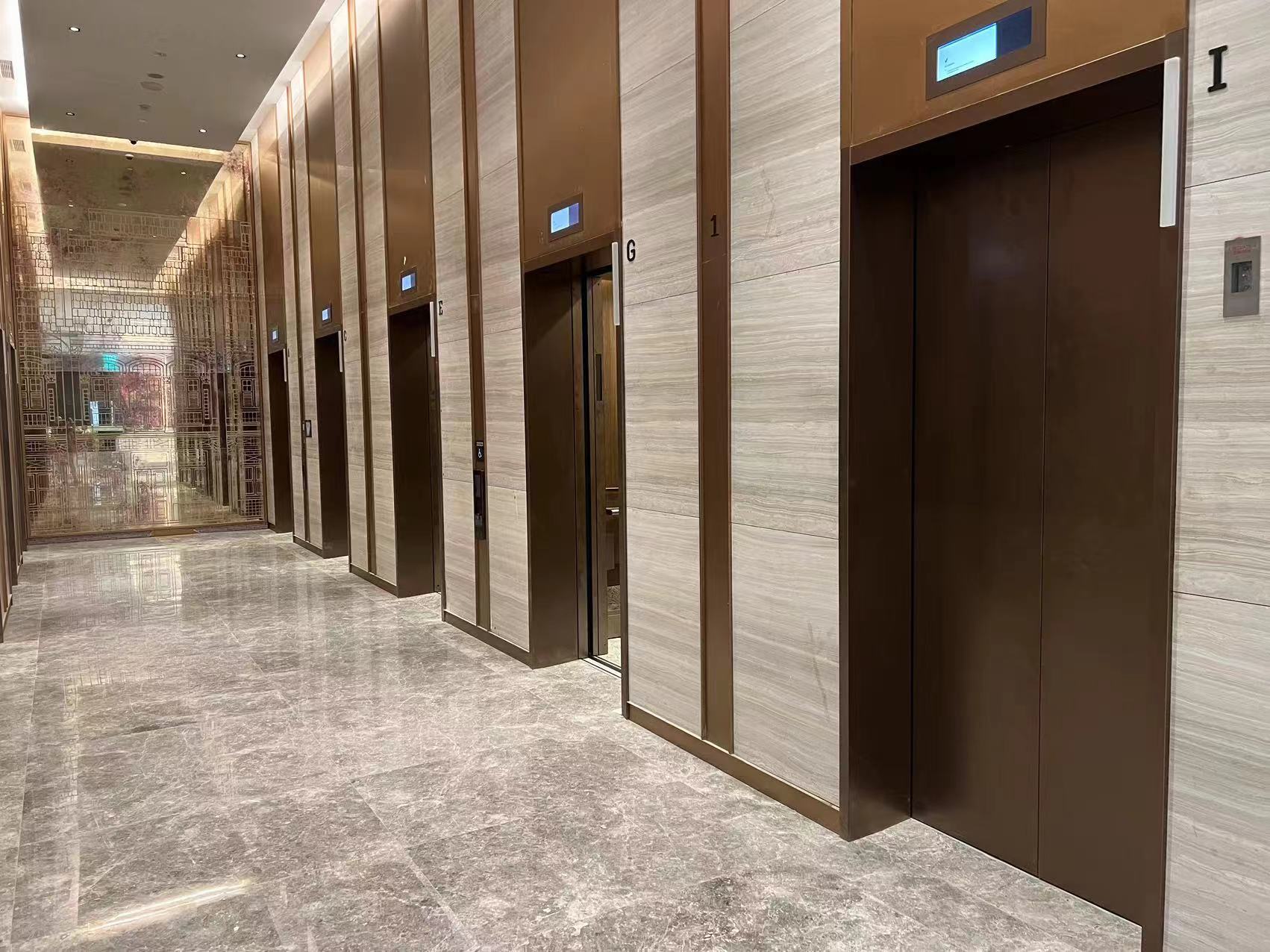 Icon Hotel Singapore lift lobby with Sandalwood Light white wood-vein marble wall cladding and polished Tundra Grey marble floor