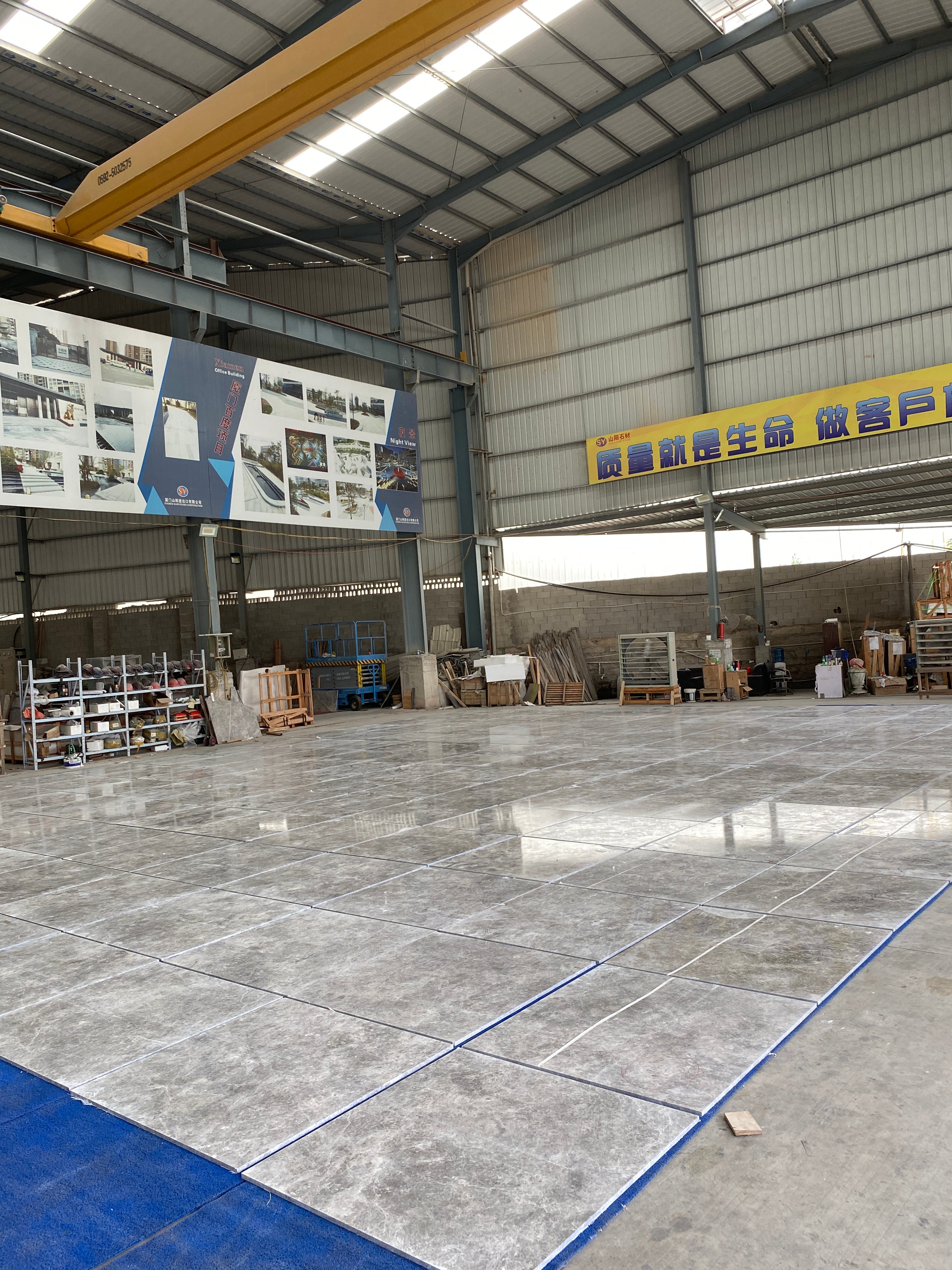 Wide view of Tundra Grey Turkish marble tiles dry-laid inside the Sun Young Stone factory warehouse
