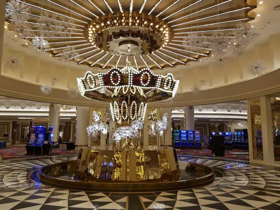 Incheon Casino gaming atrium with black-and-white waterjet marble floor beneath a feature chandelier