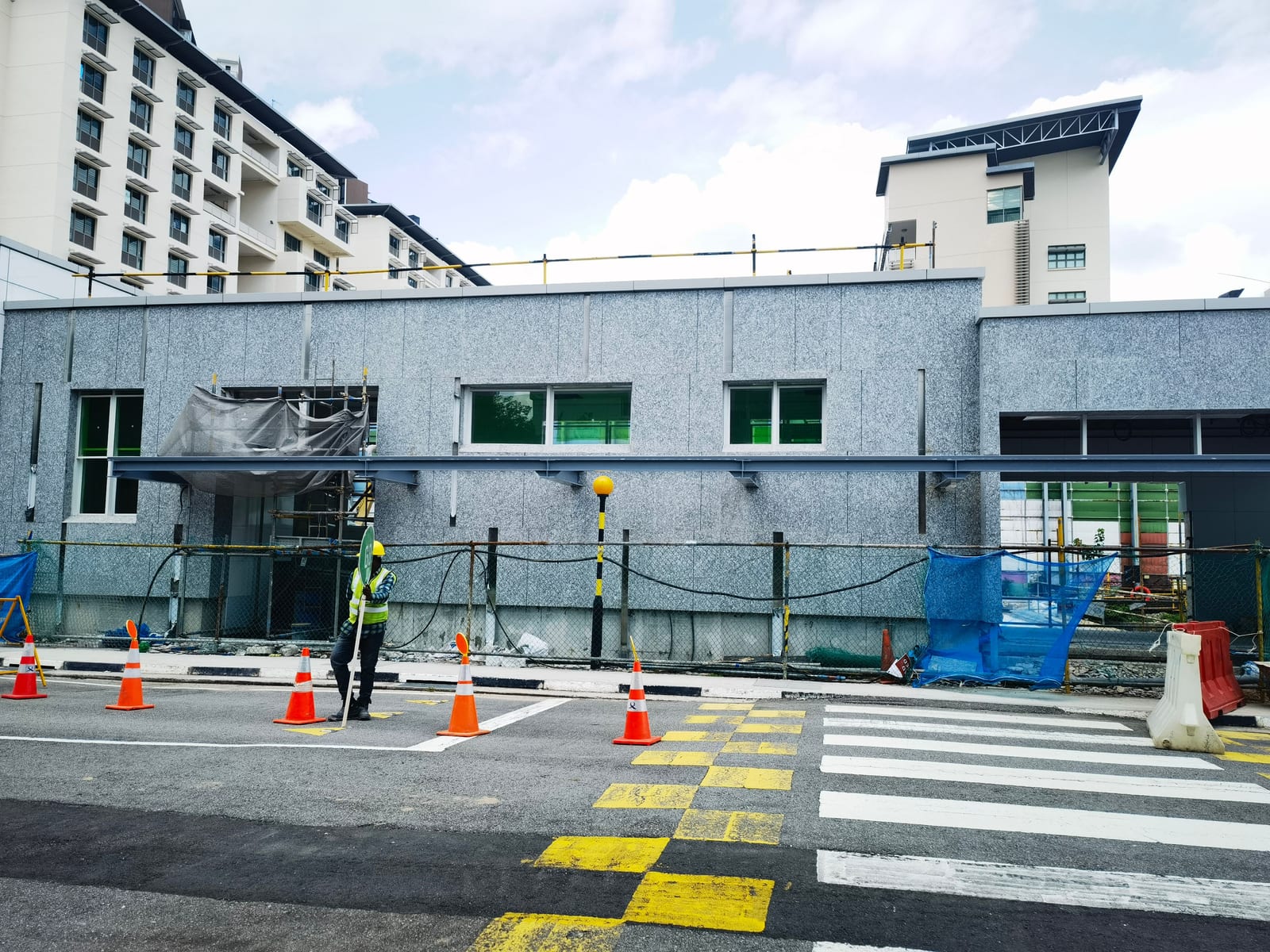 Exterior elevation of Siglap MRT Station clad in textured grey granite panels
