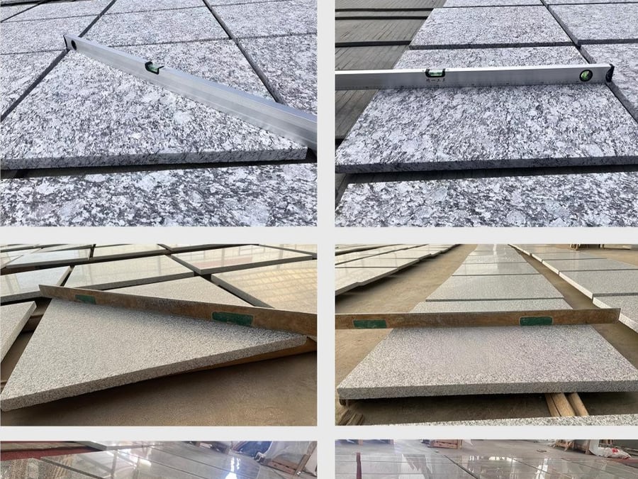 Aluminum straightedge and spirit level laid across granite tiles to check surface flatness