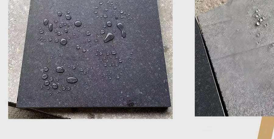 Water droplets beading on a sealed dark granite tile during a sealer performance test