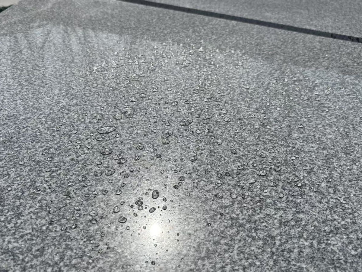 Royal Grey Granite (Medium Grey) Granite — Sealer test: water beads up, confirming the finish resists staining at Sun Young Stone