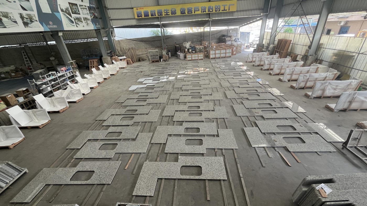 Batch of stone countertops with cut-outs dry-laid in the factory to verify dimensions before shipment