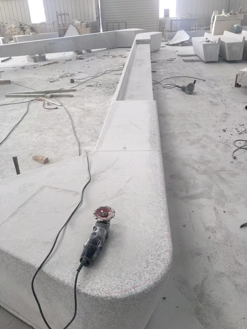 Fabricated curved granite planter wall produced from the custom shop drawing